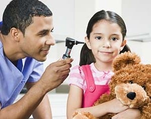 Doctor using otoscope